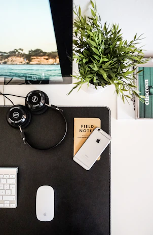 A serene workspace with headphones and a notebook open to positive affirmations.
