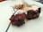 A satisfied customer with a plate of grilled meat at the restaurant.