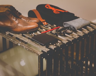 pair of brown leather dress shoes beside black leather wallet