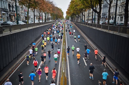 A diverse group of runners warming up together in a park, smiling and preparing for a morning workout.