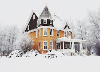 orange and gray concrete house surround by snow