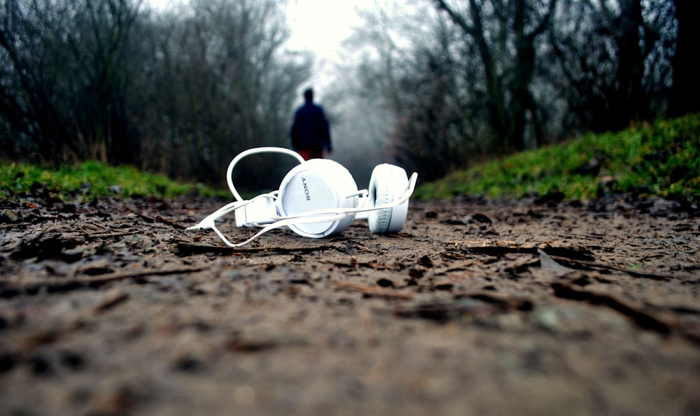 tilt shift lens photography of white corded headphones