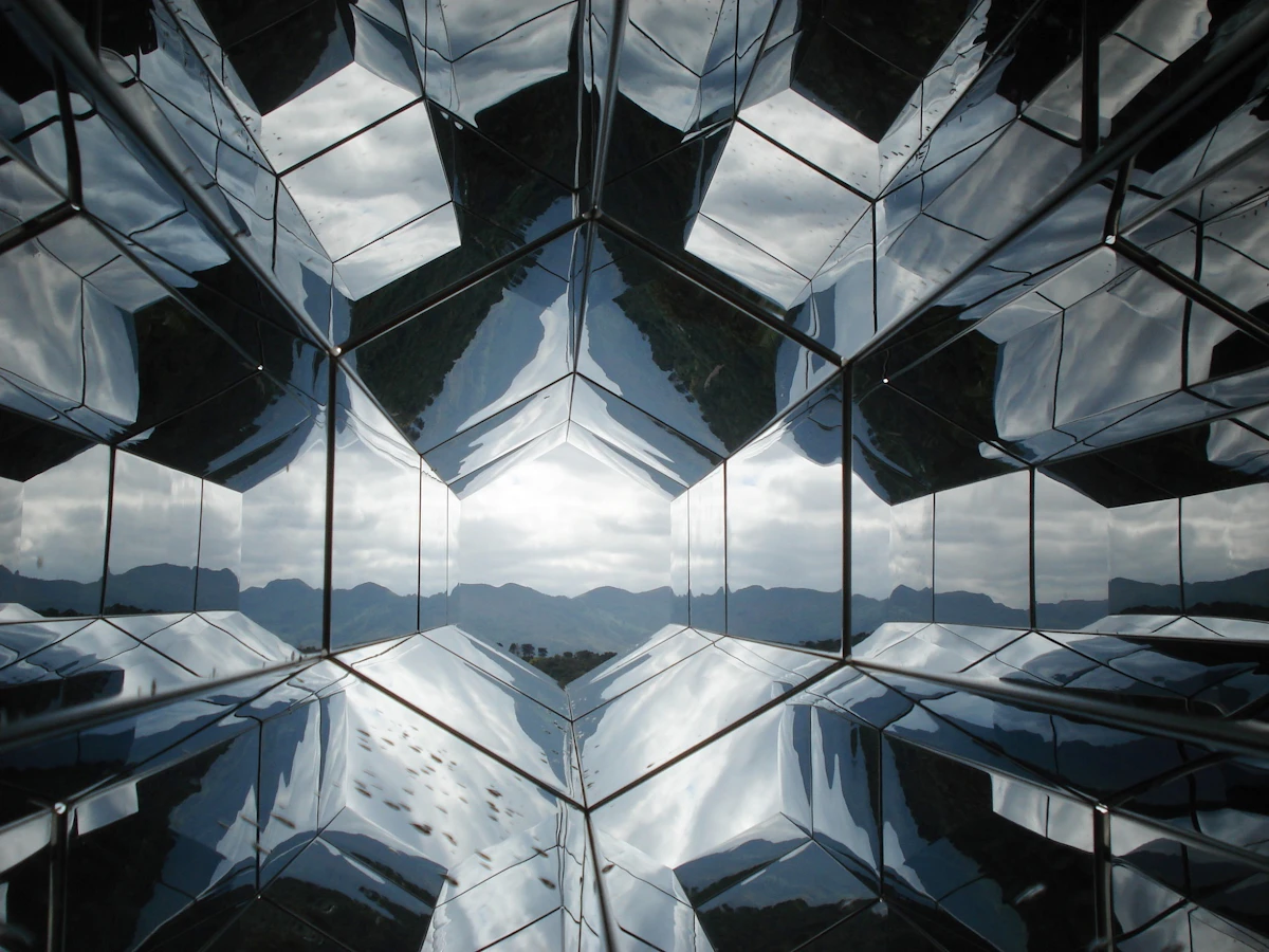 A glass-facade skyscraper reflecting a dramatic sky, architectural and forward-looking