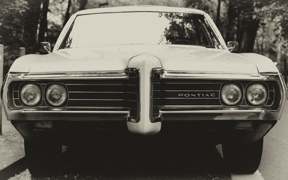 black Pontiac car on gray road