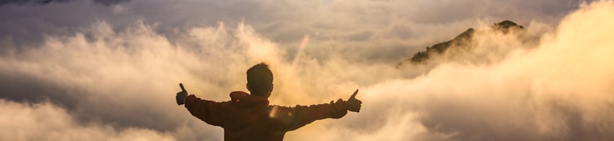 man facing clouds during golden time