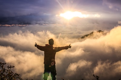 man facing clouds during golden time passionate teams background