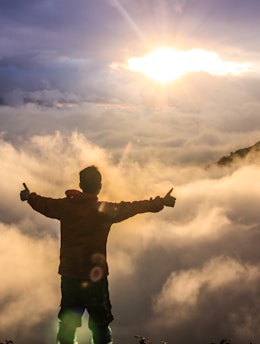 man facing clouds during golden time