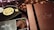 An assortment of luxury chocolates and treats are displayed. Boxes labeled Lenôtre Paris and Mariage Frères are prominently featured, suggesting high-end products. A selection of chocolates is arranged neatly on what appears to be a silk fabric background.