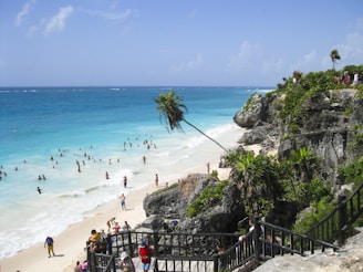 A vibrant photo of tourists enjoying a scenic beach tour in Bali with clear blue skies.