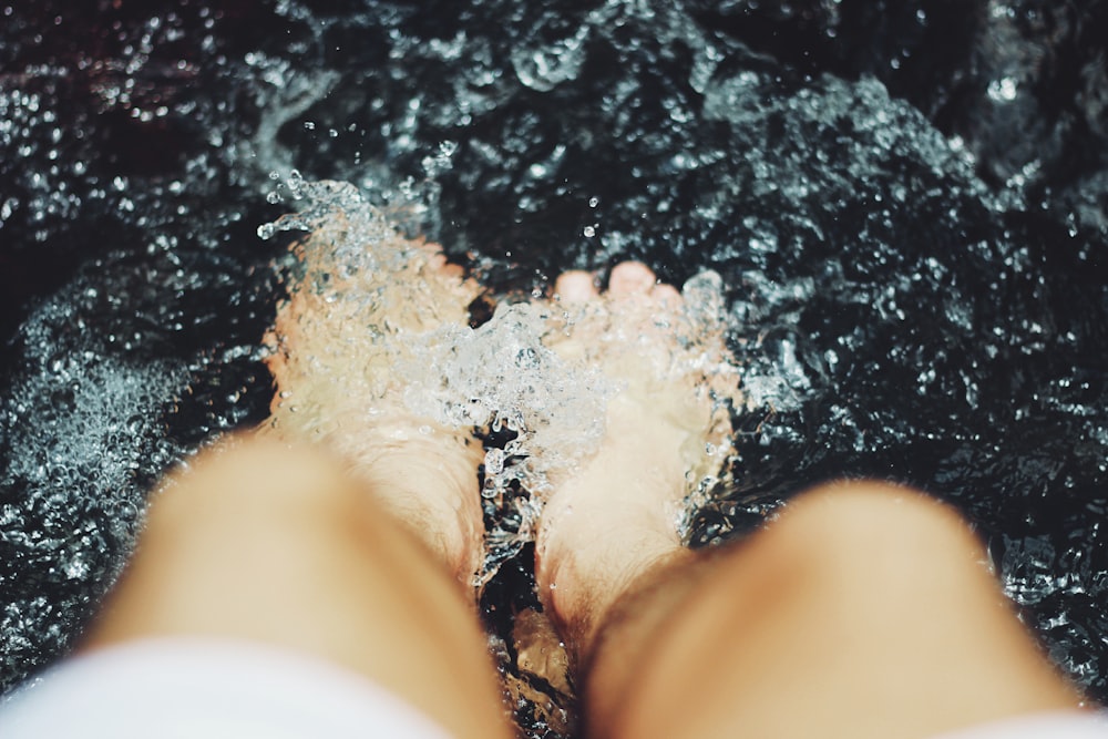 person putting his feet on water