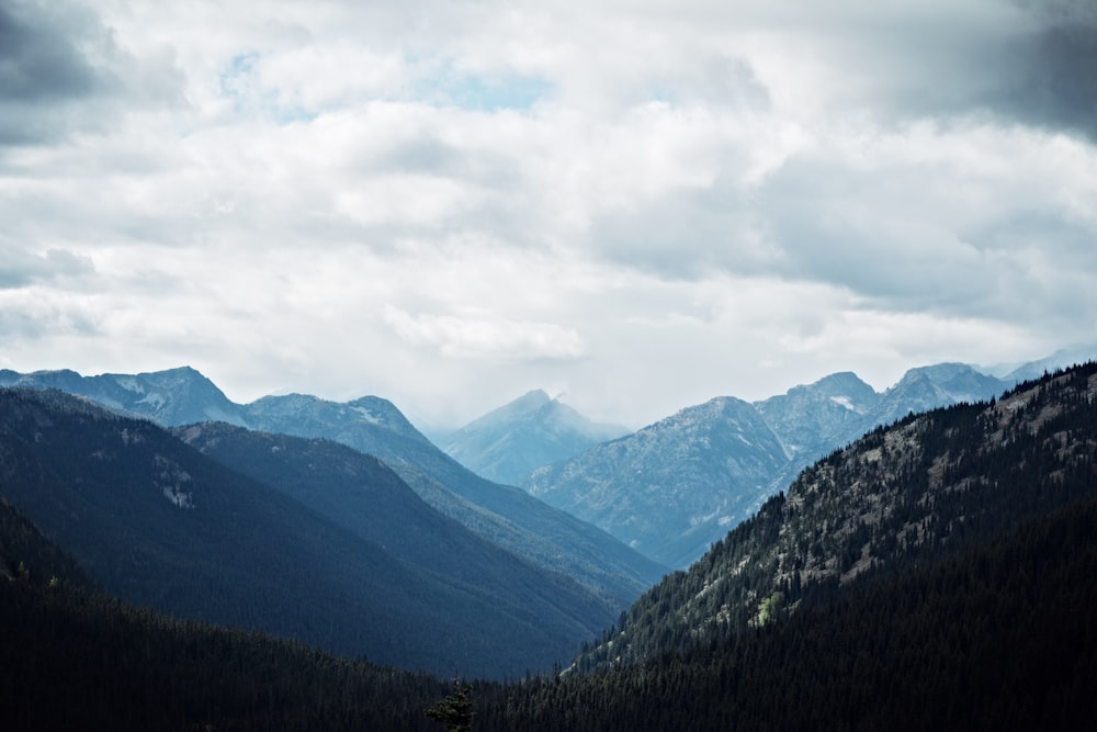 mountains under cloudy skies