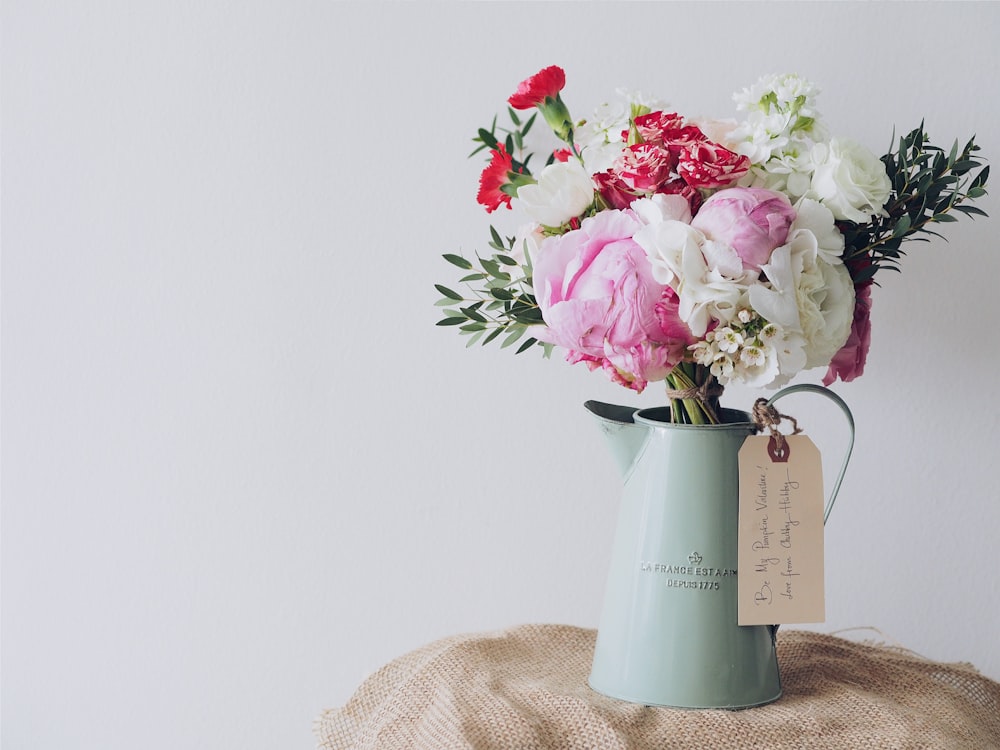 Valentine's Day floral arrangement of roses, carnations,
          and peonies in a vintage pitcher