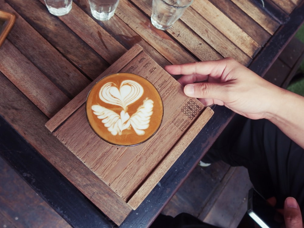 black ceramic cup on brown wooden coaster