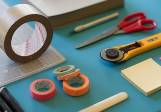 assorted-color office items on table