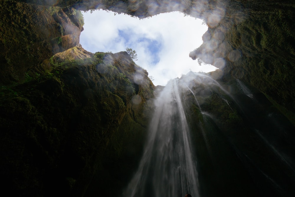 worm's eye view photo of cave waterfalls