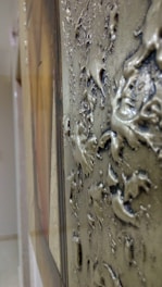 Close-up of realistic textures applied on a 3D object showing metal and fabric surfaces.