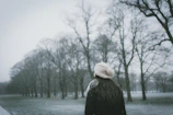 Man in a cozy sweater and scarf enjoying a winter day in a park