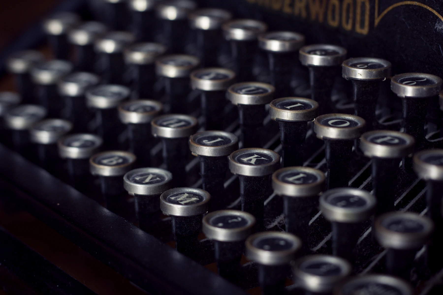 Close view of rows of round, metal-rimmed typewriter keys