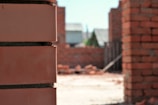 Close-up of skilled mason laying bricks on a sunny construction site.