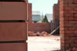 Close-up of skilled workers laying bricks on a construction site.