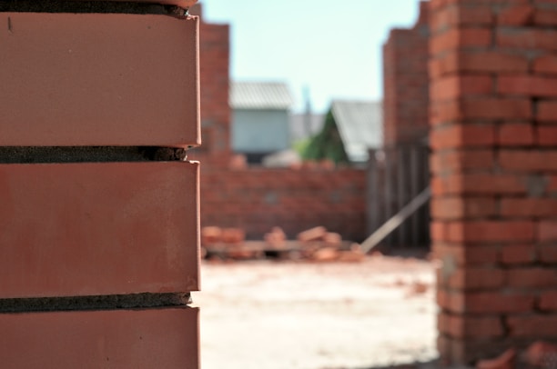 Close-up image of workers applying tiles during a construction project.