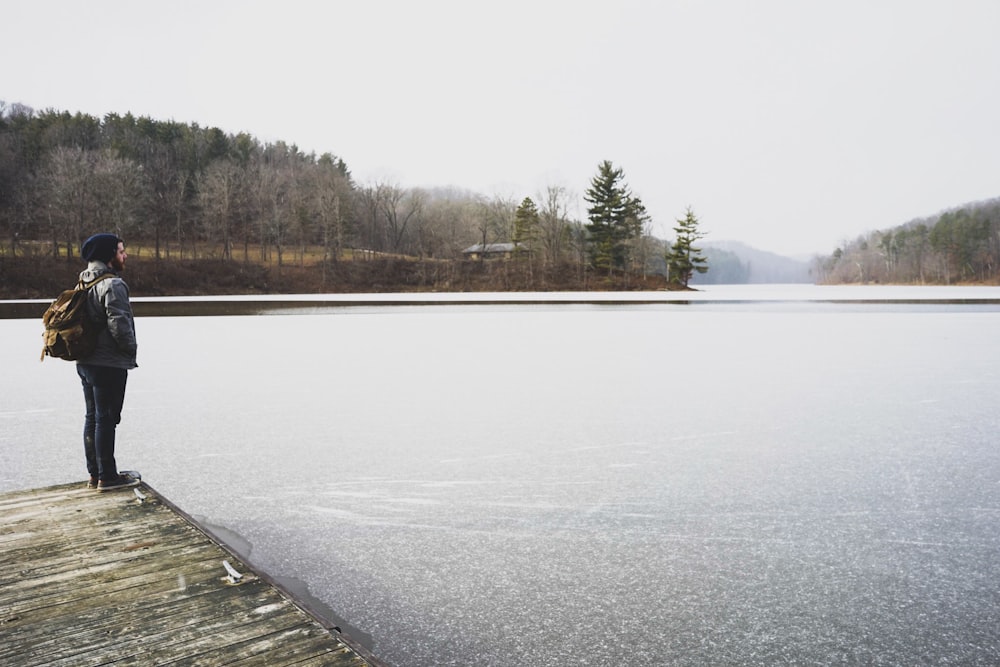 woman standing in front of lake while staring at it