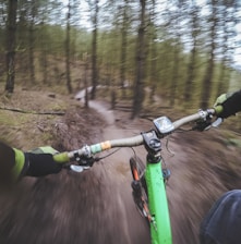 man riding green bicycle