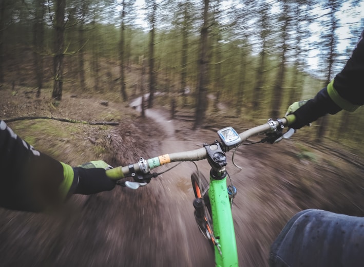 man riding green bicycle