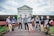 A diverse group of friends showcasing different outfits in a casual urban environment.