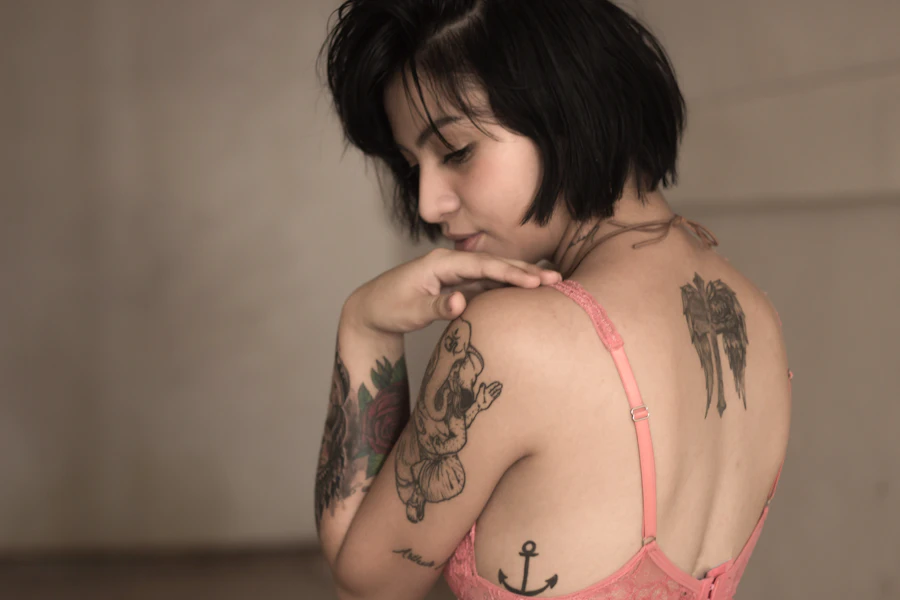 Editorial portrait of a woman with black-and-grey illustrative tattoos