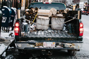pickup truck loaded by firewood while parked on concrete roadway
