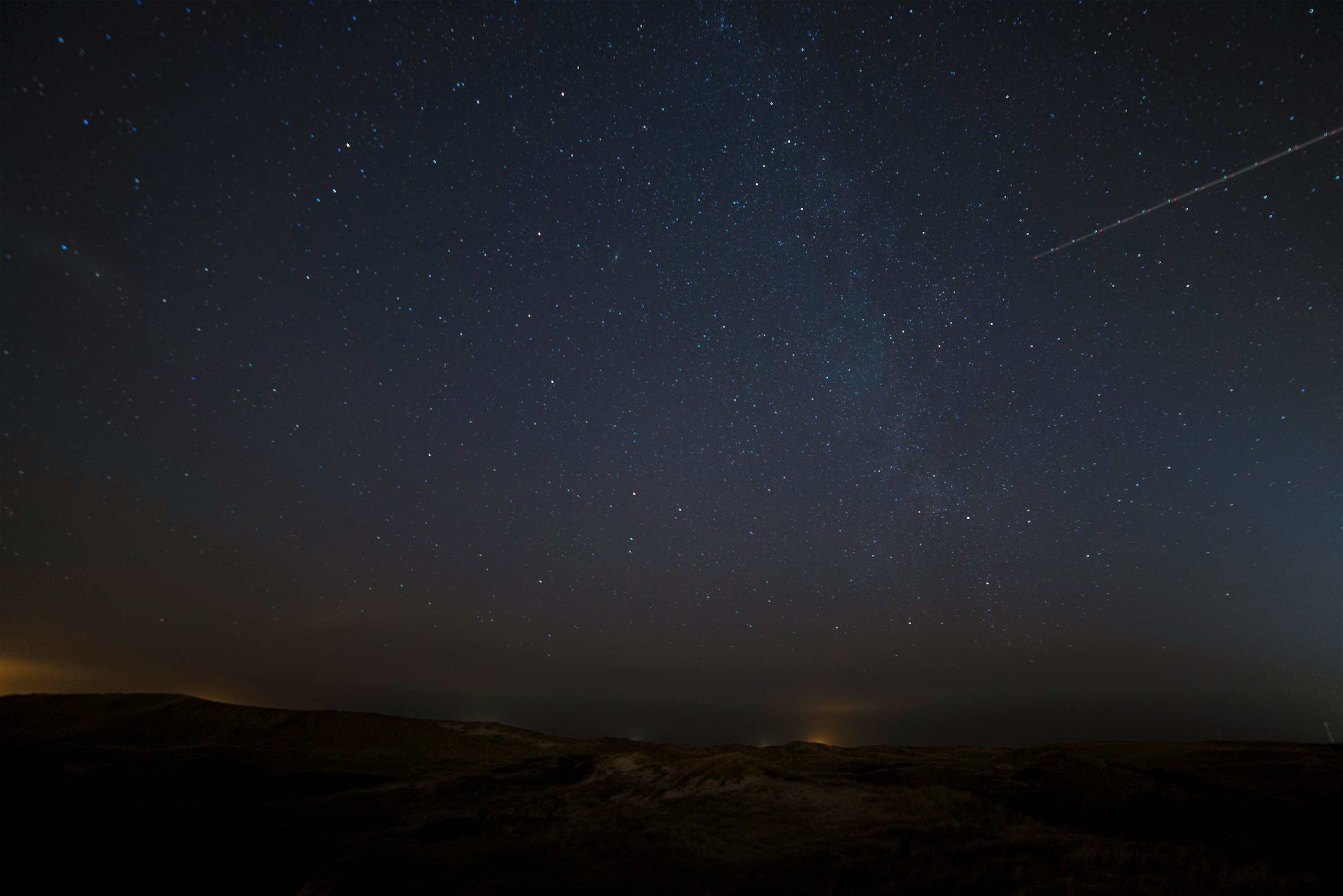landscape photograph of meteor falling in the sky