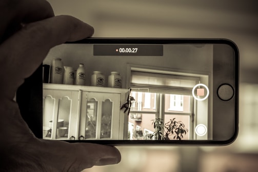 A person using a smartphone to capture evidence in a calm, organized setting.