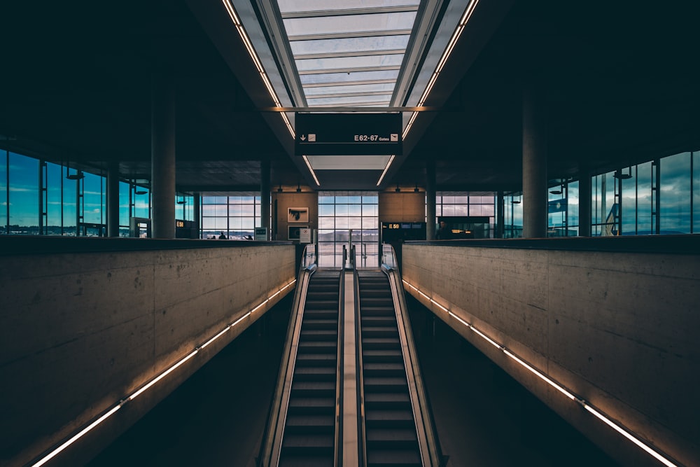 black and brown escalator inside building