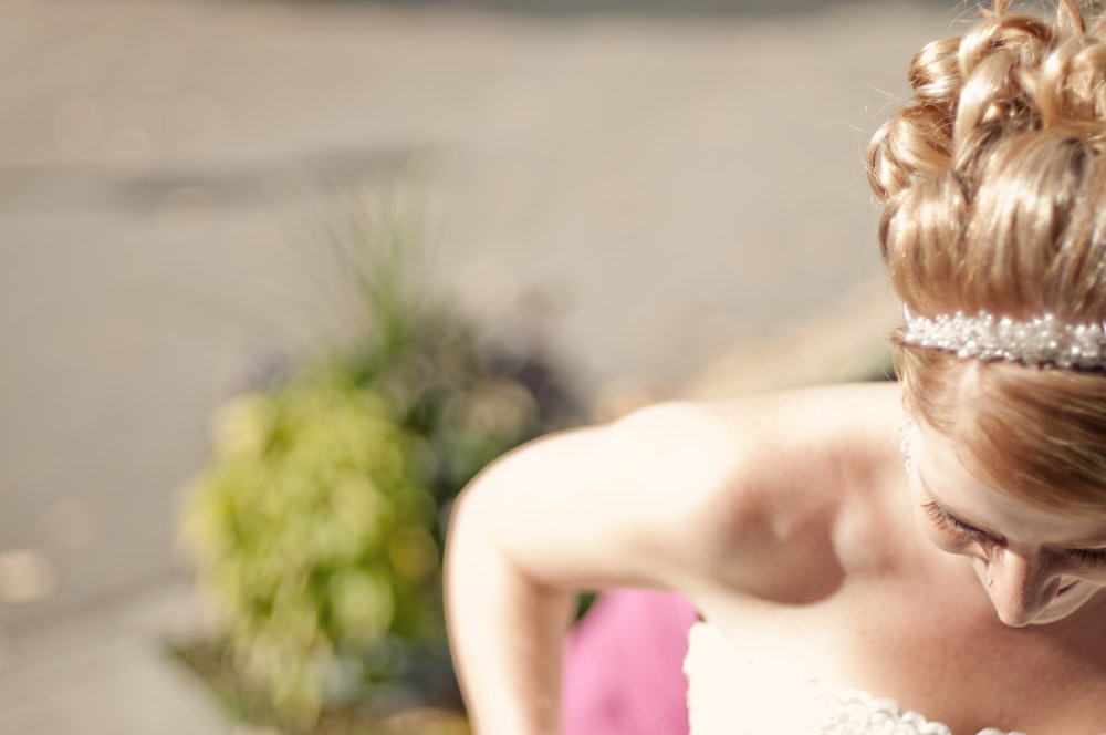 woman in white floral strapless sweetheart bridal gown shallow focus photography