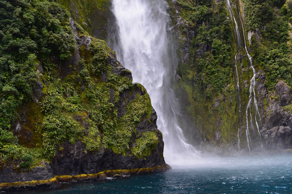 waterfall streaming through lake