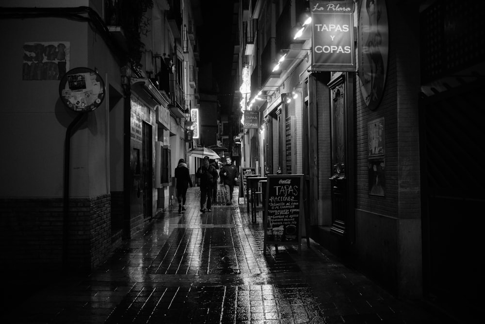 grayscale photo of people walking on street