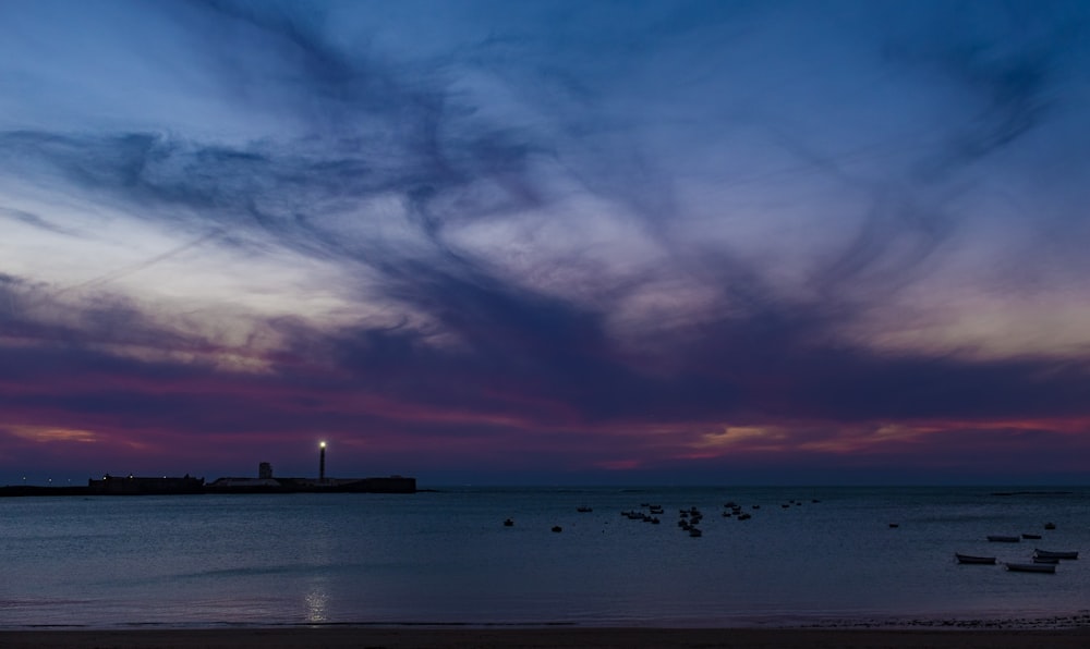 silhouette of people on beach during sunset