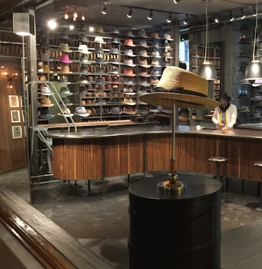 A cozy shop counter with various stylish caps displayed neatly.