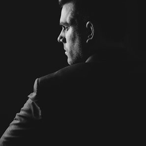 grayscale photo of man wearing blazer