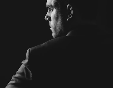 grayscale photo of man wearing blazer