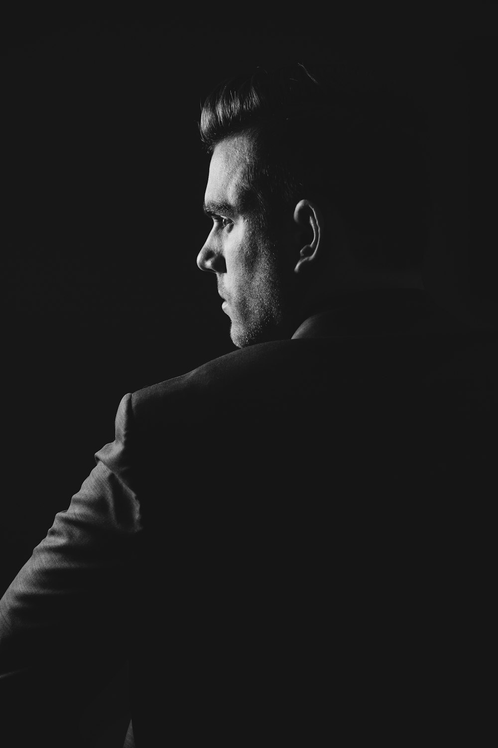 grayscale photo of man wearing blazer