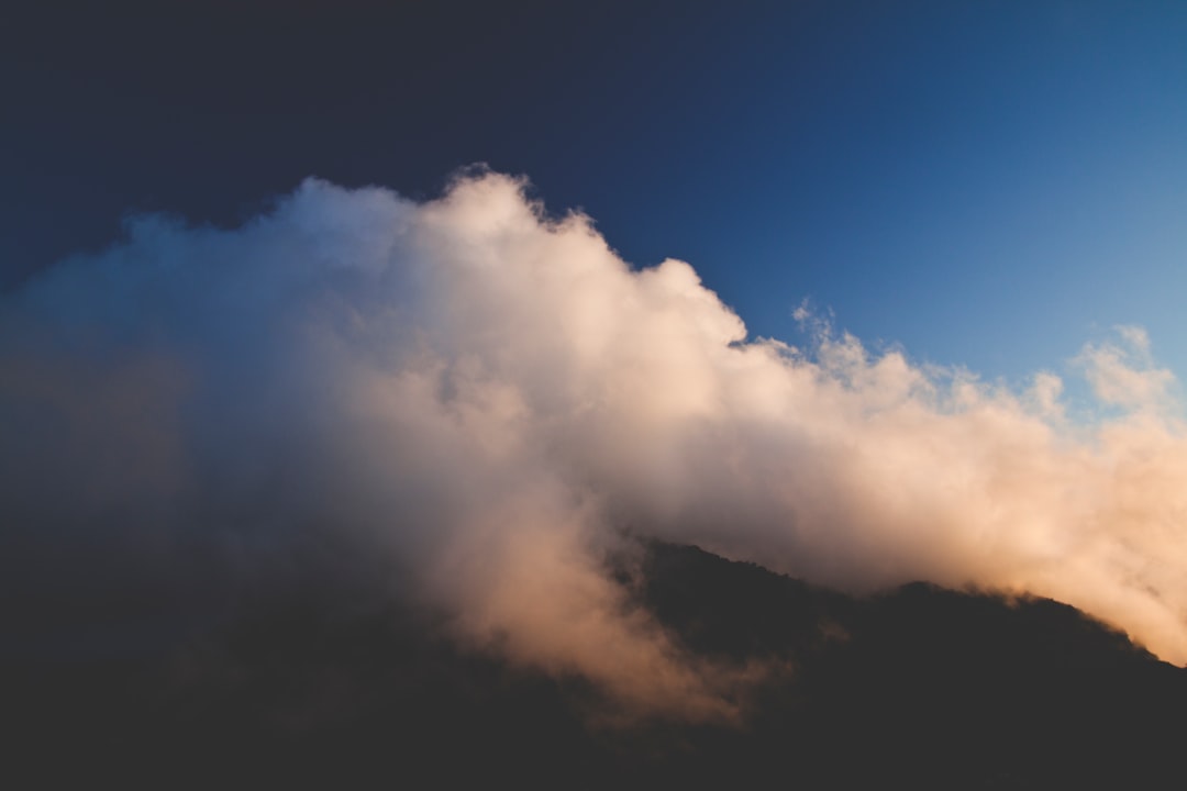 mountain top with white clouds