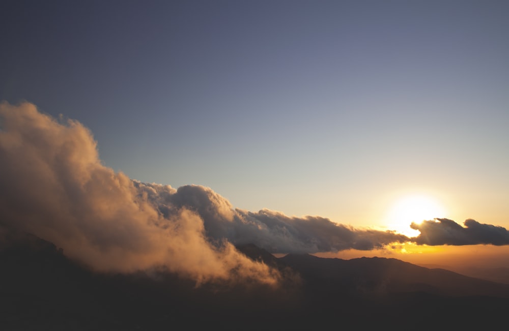 white and blue clouds covered sun