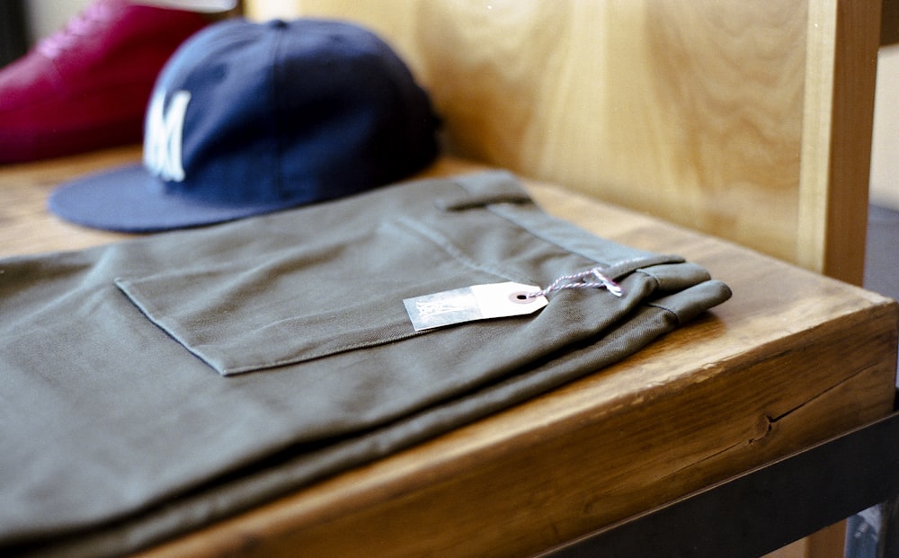 Men's hat and pants on a shelf.