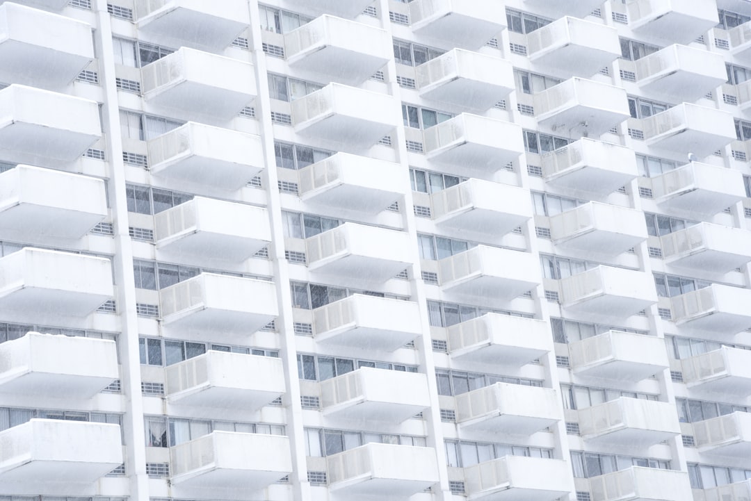 white building facade, Stern white balconies