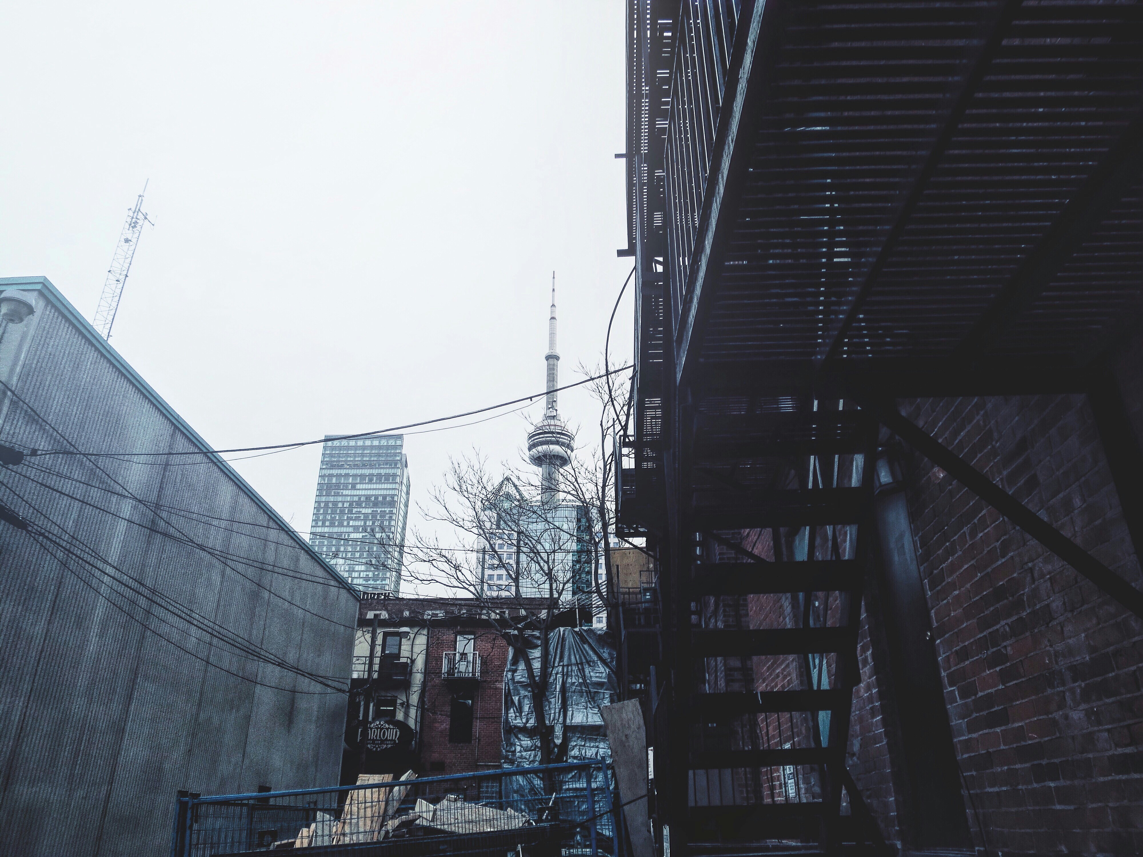 a view of a city from a narrow alleyway