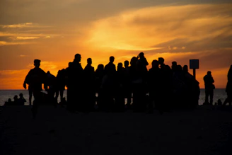A joyful group of friends enjoying a sunset on a tropical beach, capturing the essence of a perfect getaway.