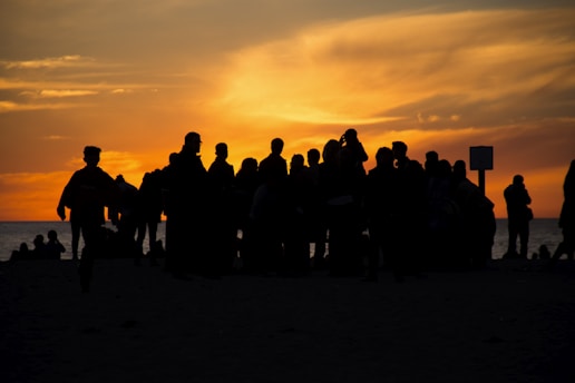 A vibrant group of adventurous young women enjoying a sunset on the beach.