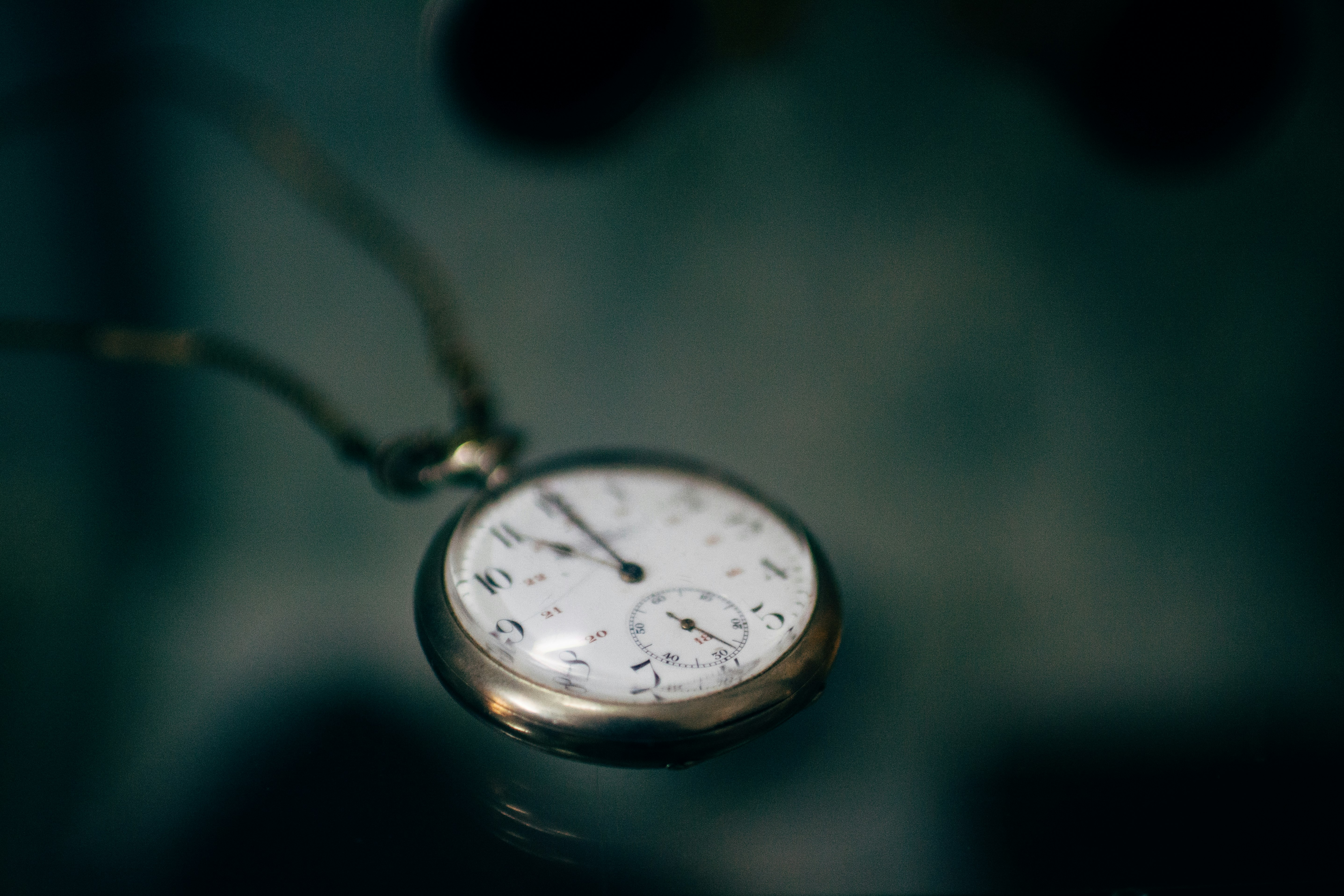 lowlight photography of white pocket watch